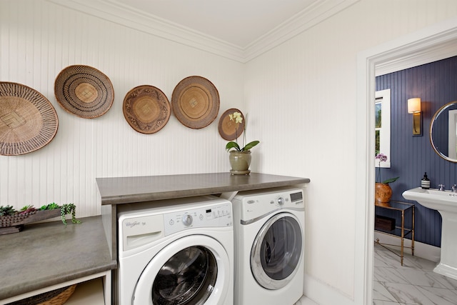 laundry room featuring washing machine and clothes dryer and crown molding