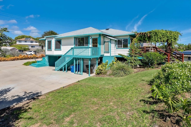 rear view of property featuring a lawn