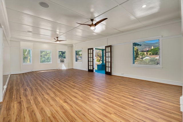 unfurnished living room with french doors, ceiling fan, and light hardwood / wood-style floors