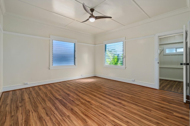 empty room with hardwood / wood-style floors, ornamental molding, and ceiling fan