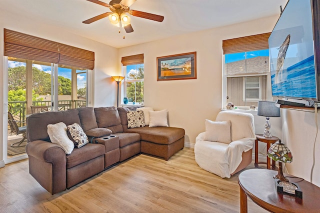 24 One Hali Ln Unit 7-203, Kihei, HI 96753 - living area with light wood-style floors, a ceiling fan, plenty of natural light, and baseboards