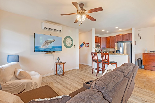 24 One Hali Ln Unit 7-203, Kihei, HI 96753 - living area with a wall mounted air conditioner, a ceiling fan, recessed lighting, baseboards, and light wood-style flooring