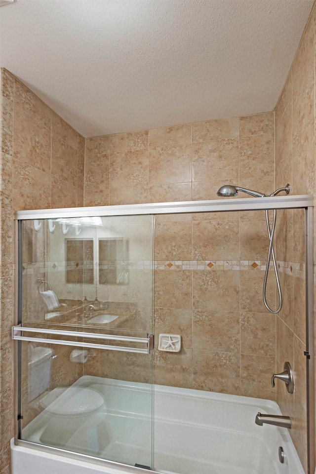 24 One Hali Ln Unit 7-203, Kihei, HI 96753 - bathroom with combined bath / shower with glass door and a textured ceiling