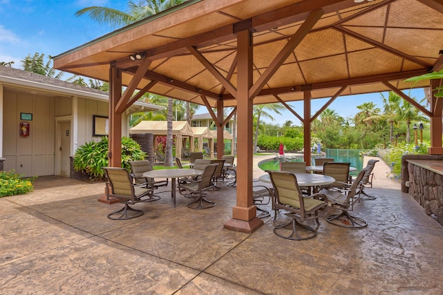 24 One Hali Ln Unit 7-203, Kihei, HI 96753 - view of patio with a gazebo, outdoor dining space, and an outdoor pool