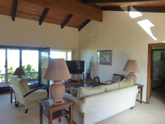 living room with wood ceiling, beam ceiling, high vaulted ceiling, and light carpet