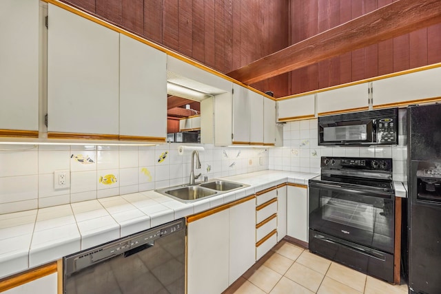 kitchen featuring tile countertops, sink, white cabinets, and black appliances