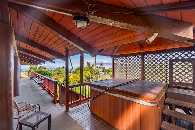 wooden deck with a hot tub