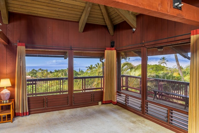 unfurnished sunroom with wooden ceiling and lofted ceiling with beams