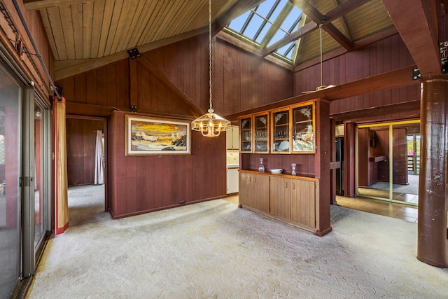 bar with light carpet, decorative light fixtures, high vaulted ceiling, and wooden ceiling