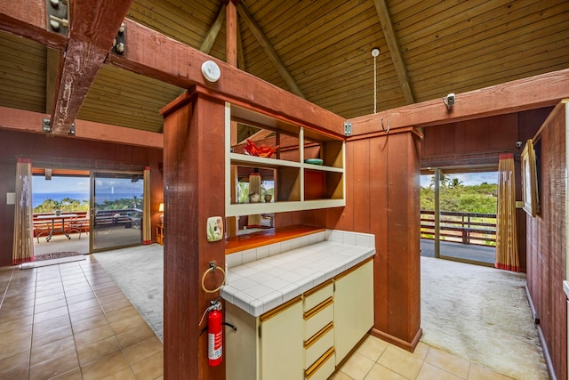 kitchen featuring tile countertops, light carpet, and plenty of natural light