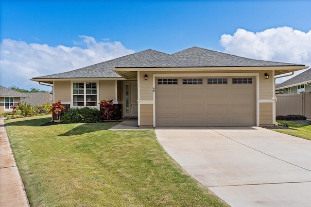 view of front of property with a garage and a front yard