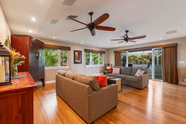 living room featuring lofted ceiling, ceiling fan, and light hardwood / wood-style flooring