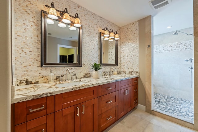 bathroom with vanity, tile patterned floors, and tiled shower