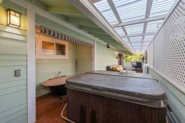 view of patio featuring a hot tub and a deck