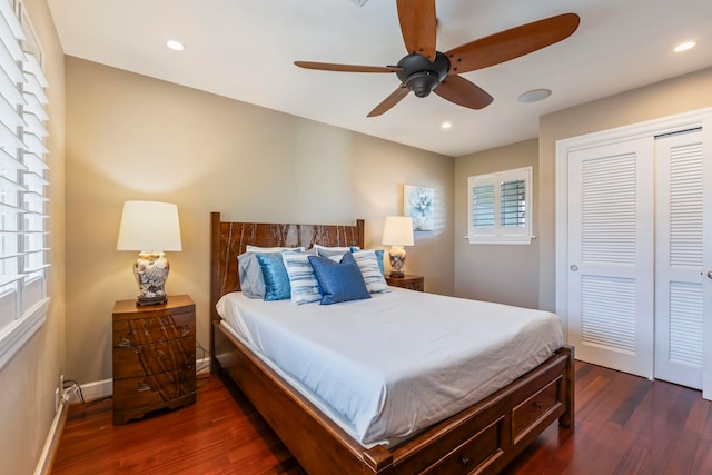 bedroom with ceiling fan, dark hardwood / wood-style floors, and a closet