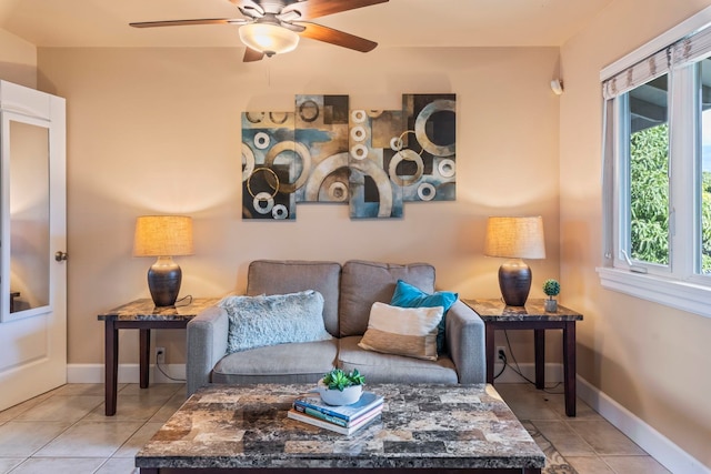 living room featuring a wealth of natural light, light tile patterned floors, and ceiling fan