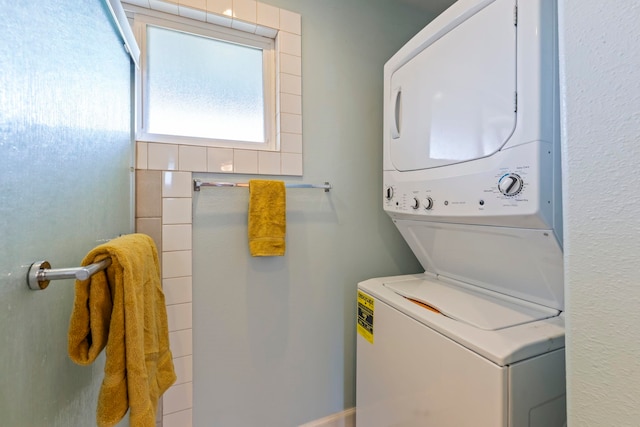 clothes washing area with stacked washer and clothes dryer