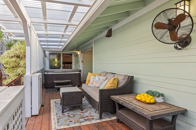 deck with a hot tub, an outdoor living space, and ceiling fan