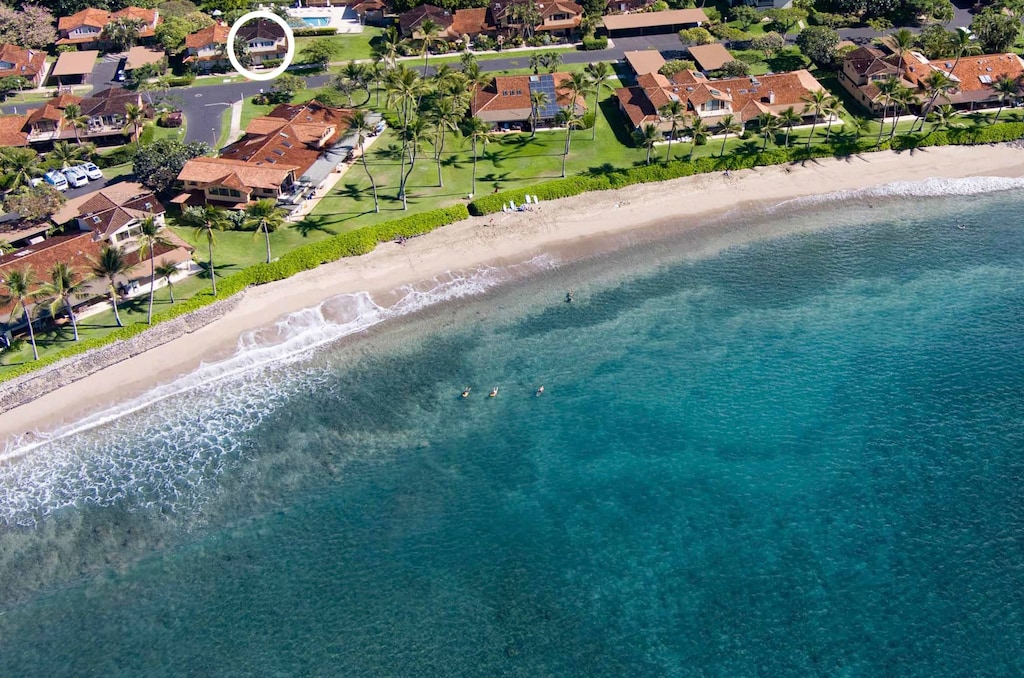 aerial view featuring a view of the beach and a water view