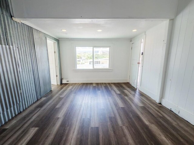 225 S Papa Ave, Kahului, HI 96732 - empty room with dark wood-style flooring, ornamental molding, and baseboards