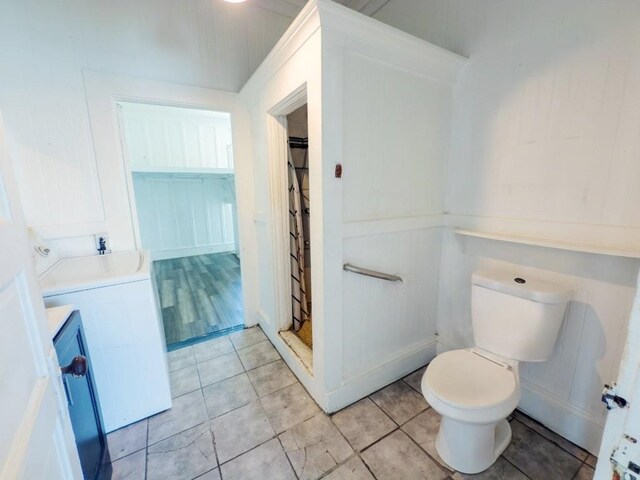225 S Papa Ave, Kahului, HI 96732 - bathroom with washer / dryer, curtained shower, toilet, and tile patterned floors