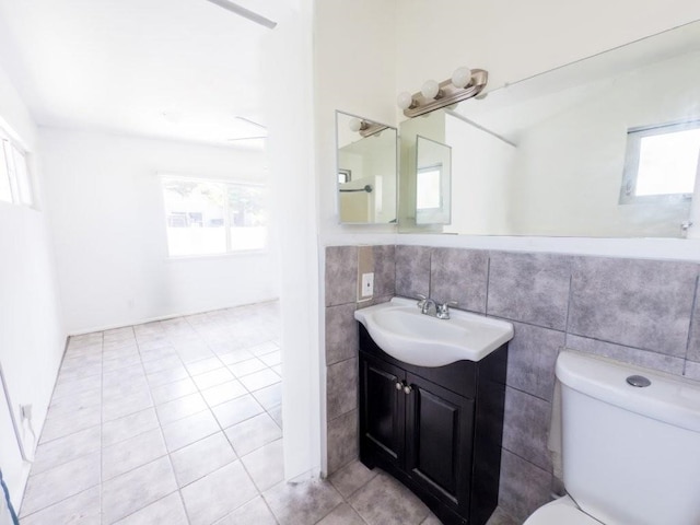225 S Papa Ave, Kahului, HI 96732 - bathroom featuring healthy amount of natural light, tile patterned flooring, toilet, tile walls, and vanity