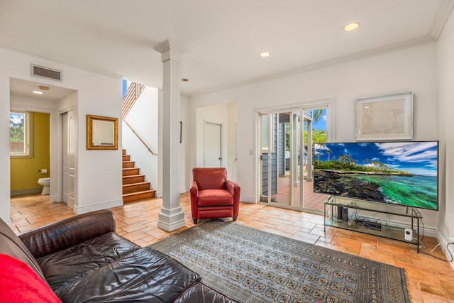 tiled living room featuring ornamental molding, plenty of natural light, and ornate columns