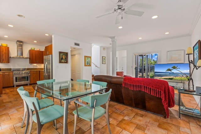 tiled dining area featuring ceiling fan, crown molding, and decorative columns