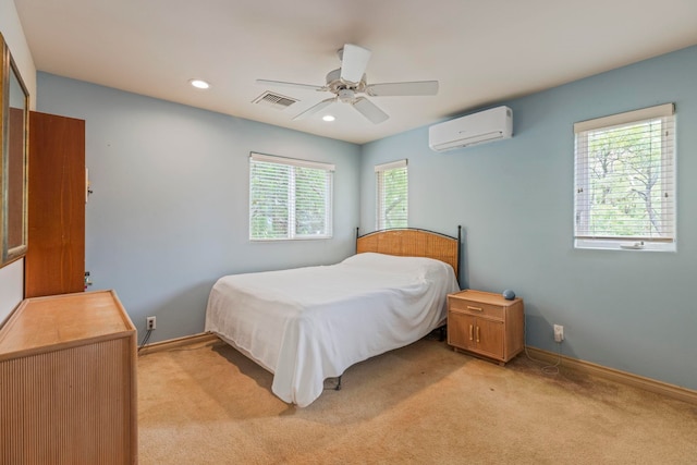 carpeted bedroom featuring ceiling fan, multiple windows, and a wall unit AC