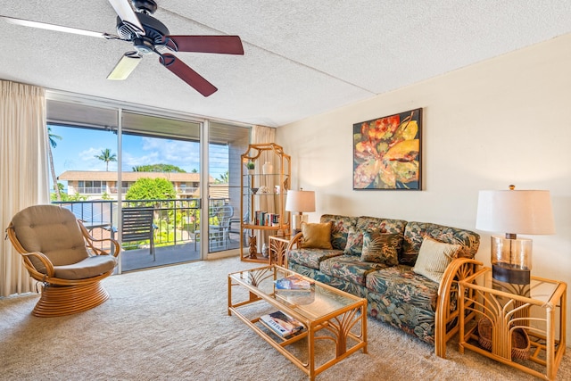 2495 S Kihei Rd Unit 248, Kihei, HI 96753 - living area featuring carpet floors, expansive windows, ceiling fan, and a textured ceiling