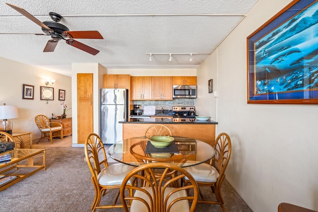 2495 S Kihei Rd Unit 248, Kihei, HI 96753 - dining space with ceiling fan, carpet floors, track lighting, and a textured ceiling