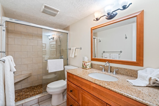 2495 S Kihei Rd Unit 248, Kihei, HI 96753 - full bath featuring a shower stall, toilet, vanity, tile patterned flooring, and a textured ceiling