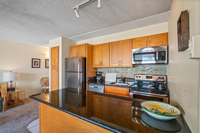 2495 S Kihei Rd Unit 248, Kihei, HI 96753 - kitchen with stainless steel appliances, a sink, carpet flooring, decorative backsplash, and dark stone counters