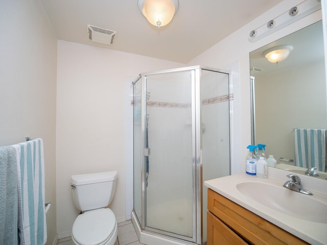 bathroom with toilet, vanity, tile patterned flooring, and walk in shower