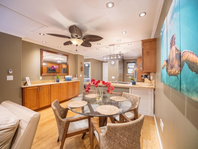 dining room featuring a ceiling fan, recessed lighting, crown molding, and light wood-style flooring