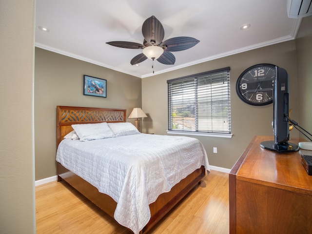 bedroom featuring a ceiling fan, baseboards, light wood-style floors, an AC wall unit, and crown molding