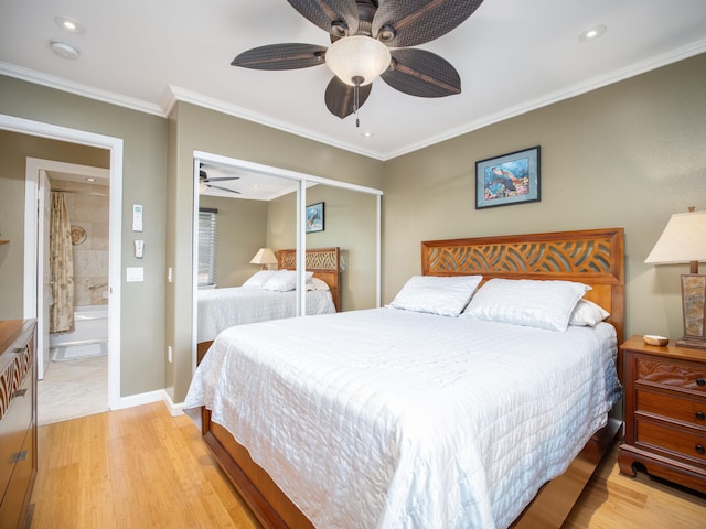 bedroom with light hardwood / wood-style flooring, crown molding, a closet, ceiling fan, and connected bathroom