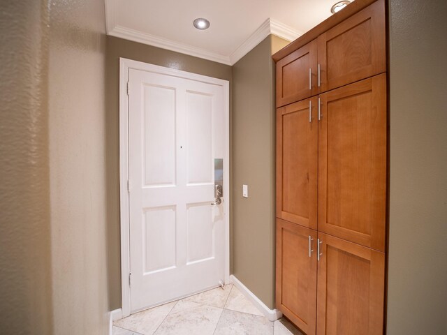 doorway featuring baseboards and ornamental molding