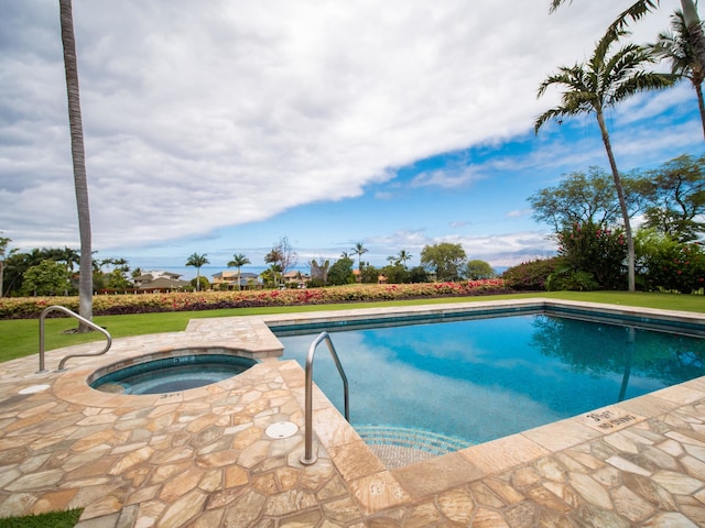 view of swimming pool with an in ground hot tub