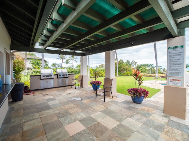 view of patio with area for grilling and a grill