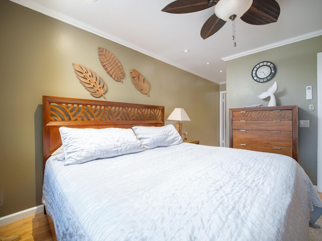 bedroom with ceiling fan, crown molding, and hardwood / wood-style floors