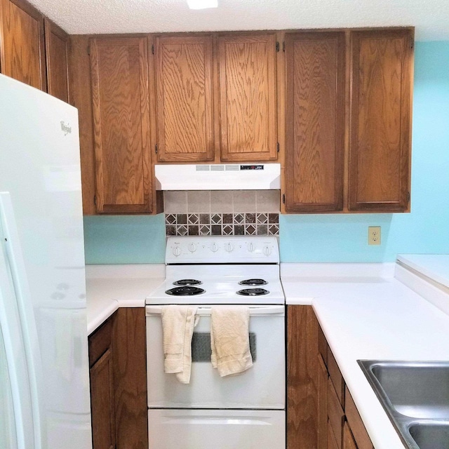 kitchen with white appliances and backsplash