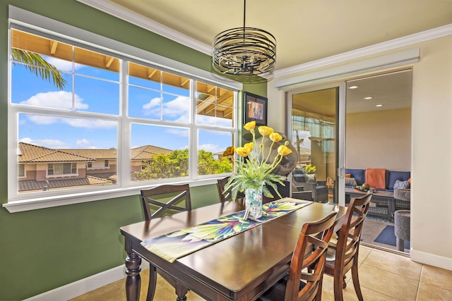 dining room with crown molding, baseboards, an inviting chandelier, and light tile patterned floors