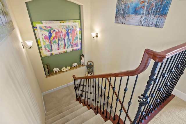 stairs featuring carpet floors and baseboards
