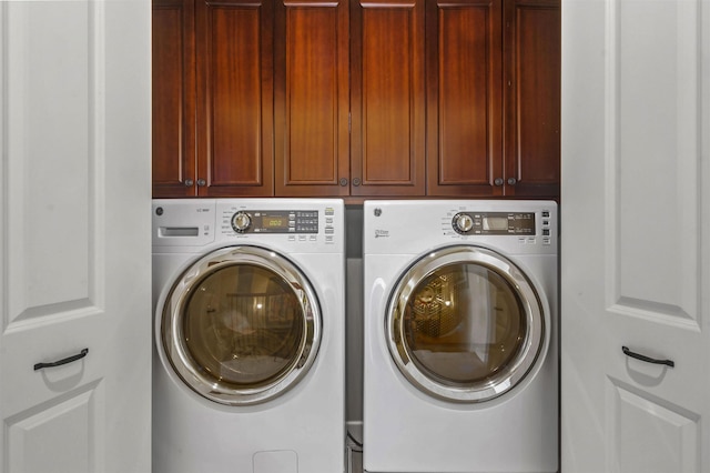 laundry area with cabinet space and washing machine and clothes dryer