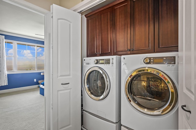 laundry area featuring washer and dryer, baseboards, carpet floors, and cabinet space