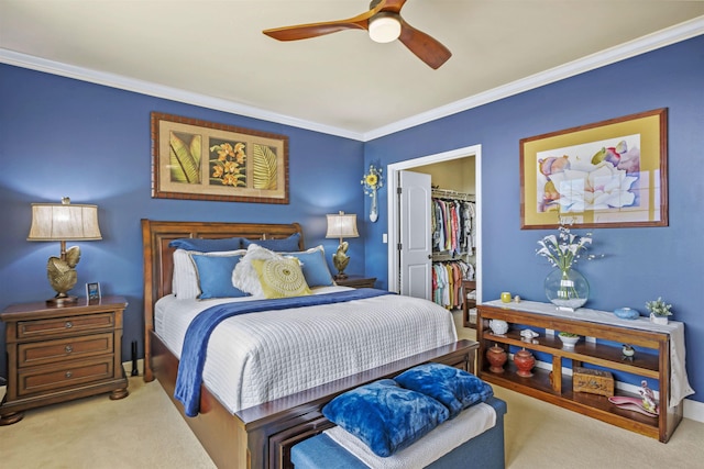 bedroom featuring crown molding, carpet, a walk in closet, and a closet