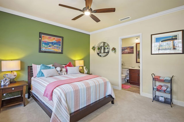 bedroom with crown molding, connected bathroom, light colored carpet, baseboards, and visible vents