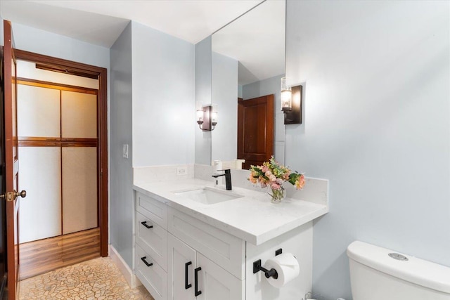 bathroom featuring toilet and vanity