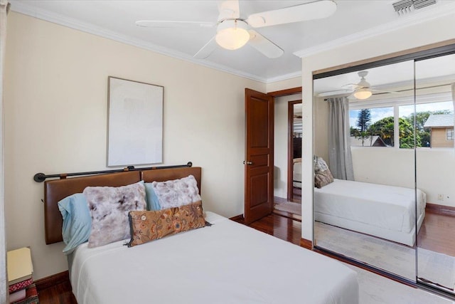 bedroom with ornamental molding, dark hardwood / wood-style floors, and ceiling fan